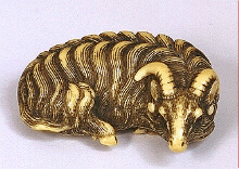 Tomotada school - An ivory netsuke of a reclining goat, late 18th century.  Signed: Tomotada, Kyoto