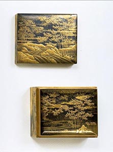 A fine Kogo (box) decorated in gold on black with a scene of bamboo growing by a running stream